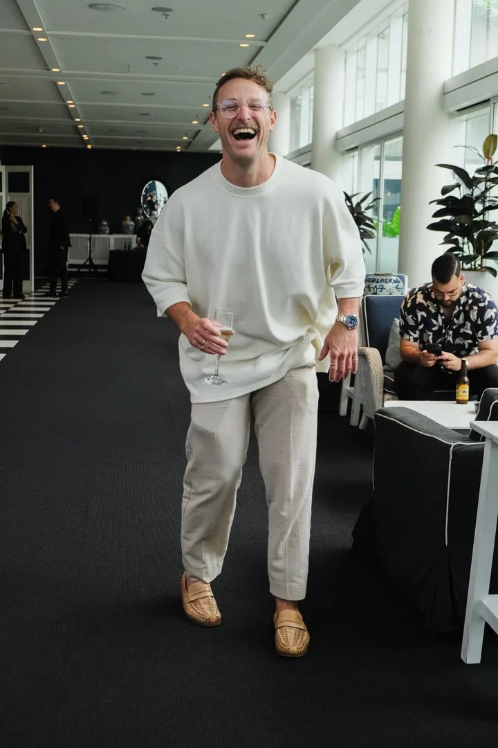 Brando laughing with business owners at an event