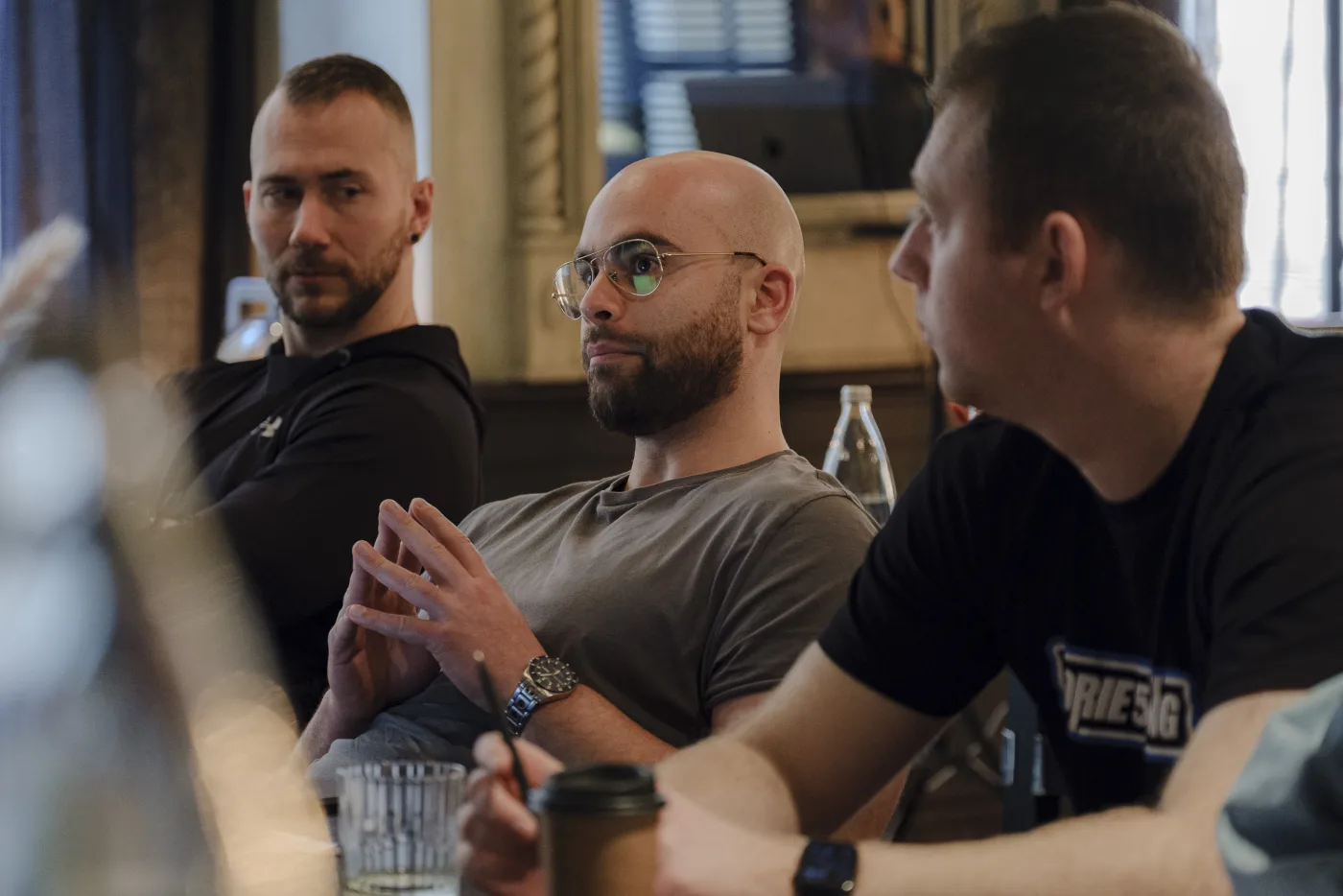 Kaizen working around a table with business owners